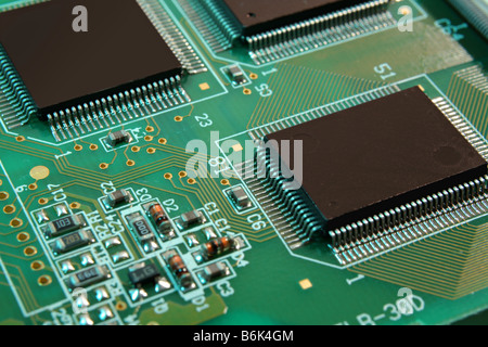 macro close-up of a circuit board showing microchips and other computer components Stock Photo
