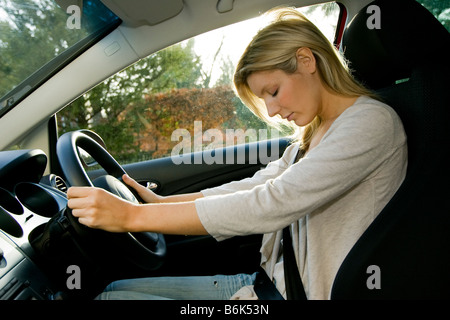 Woman falling asleep whilst driving Stock Photo