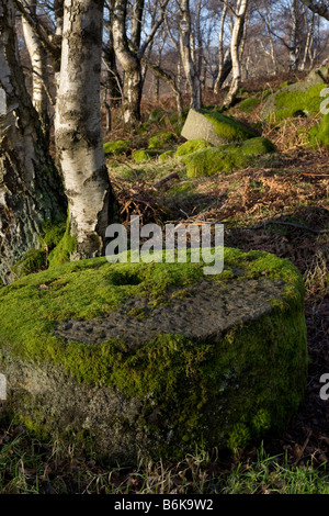Hathersage. Carved, chiselled round, abandoned mill wheel, old, rural, ancient millstone.  Mill Stones in Peak District National Park, Derbyshire, UK Stock Photo