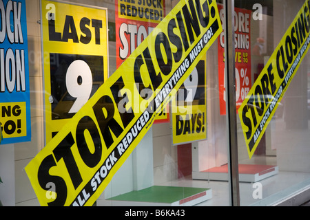 Signs saying All Stock Reduced, Everything must go Store Closing in Derby High Street, Credit Crunch Discounts Signs, Derbyshire, UK Stock Photo