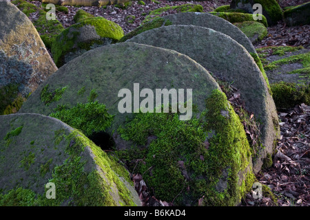 Hathersage. Carved, chiselled round, abandoned mill wheel, old, rural, ancient millstone.  Mill Stones in Peak District National Park, Derbyshire, UK Stock Photo