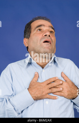 Man hands grabbing chest having a heart attack Stock Photo