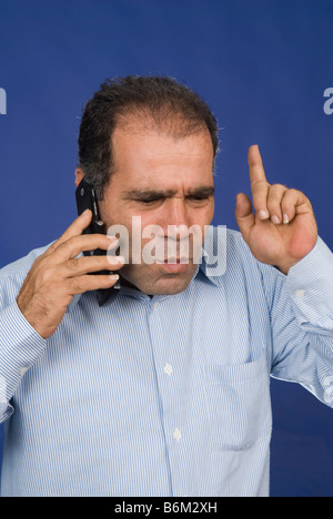 Man having an argument on mobile phone Stock Photo
