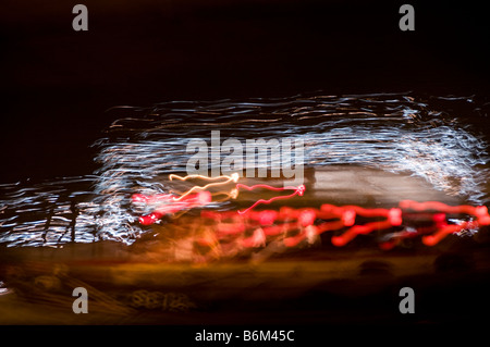 Blurred lights on moving boat Stock Photo