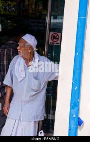 Portrait of Indian man standing in doorway in Singapore Little India Stock Photo