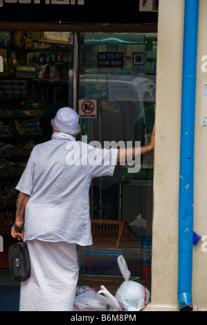 Portrait of Indian man standing in doorway in Singapore Little India Stock Photo