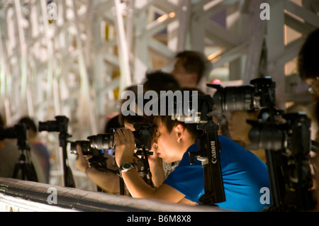 Paparazzi photographers taking photographs at night of special event Stock Photo