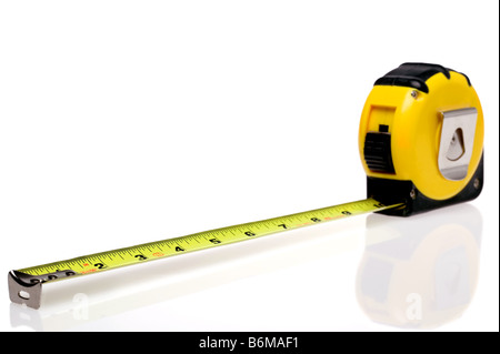 A yellow retractable steel tape measure isolated on a white background with slight reflection Stock Photo
