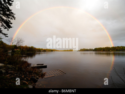 full rainbow over the water Stock Photo