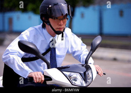 Young businessman riding motorcycle Stock Photo