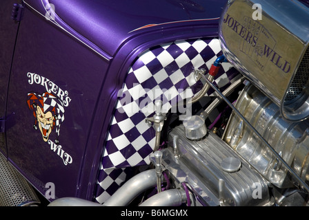 A photo showing the custom design work on the front of a purple hot rod. Stock Photo