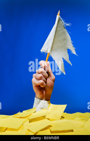 Businessman show white flag under a mountain of adhesive notes. Please give a break from all these stressful commitments Stock Photo