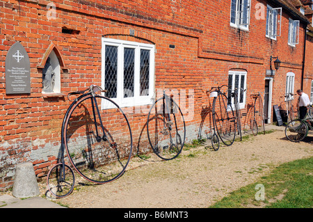 Veteran cycles at Buckler s Hard Beaulieu Hants a row of penny farthing cycles Stock Photo
