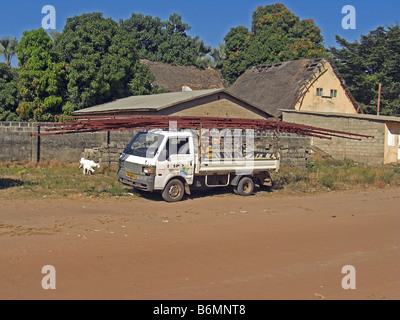 Roof trusses being loaded on a small van in The Gambia, West Africa Stock Photo