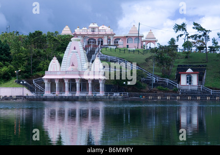 Details of shrine, land and buildings with reflections in the holy lake at the sacred site of Grand Bassin, Mauritius Stock Photo