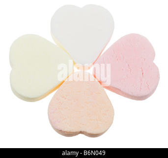 candy heart shaped sweets in a clover shape lucky in love isolated on a white background Stock Photo