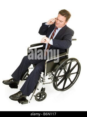 Businessman in wheelchair talking on his phone and checking the time Full Body isolated on white Stock Photo