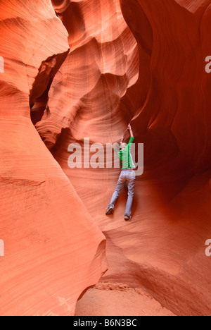 Girl rock climbing in Secret Slot Canyon, Paige, Arizona, USA Stock Photo