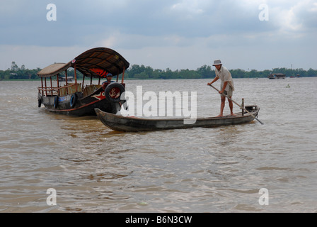 Man on sampan, Tien Giang River, Mekong Delta Vietnam Stock Photo