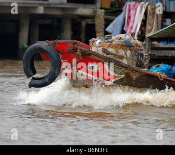 Bow wave and broken fender, Vietnamese river boat, Mekong Delta Stock Photo