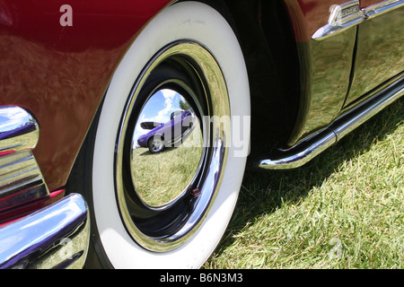 A well kept classic car parked on the grass. Stock Photo