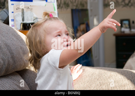 1 to 2 year old toddler girl upset and crying having tantrum Stock Photo