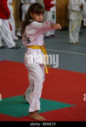 Girl performs karate demonstration on the sport arena Stock Photo