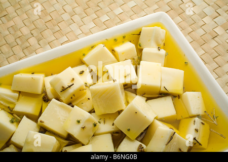queso al tomillo en aceite de oliva virgen extra thyme cheese in extra virgin olive oil Stock Photo