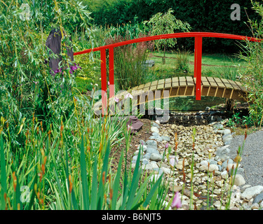 Red bridge in a japanese garden Stock Photo - Alamy