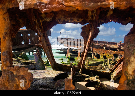 Image looking through the rusted remains of the shipwreck of the Maheno on the coast of Fraser Island Australia Stock Photo