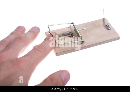 Mans hand catched in mousetrap over white Stock Photo