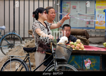 Chinese women in discussion on a street of HoHot, Inner Mongolia, northern China Stock Photo