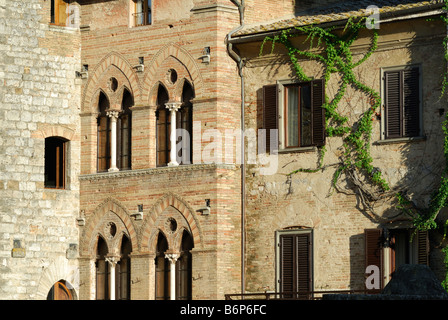 San Gimignano Tuscany Italy Asoorted window styles of buildings on Piazza della Cisterna Stock Photo