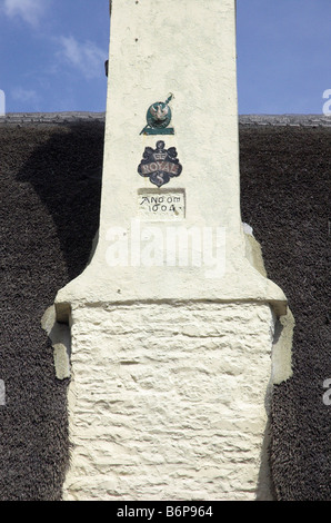 An old chimney with fire insurance badges in Porlock in Devon Stock Photo