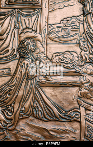 Biblical scenes in hammered copper on the doors of a cathedral in Quebec Stock Photo