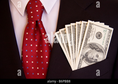 Hundred dollar bills in man's suit pocket Stock Photo