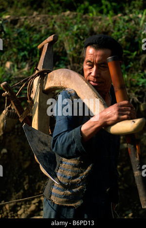 Vietnam, Ha Giang province, Meo Vac, H'mong ethnic minority, man carrying a wooden plough Stock Photo