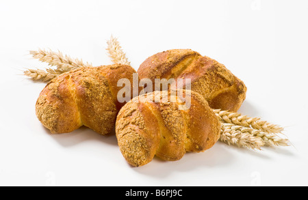 Crisp bread rolls and wheat ears Stock Photo