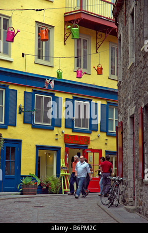 A street in Old Quebec with bright buildings and watering cans converted to lamps Stock Photo