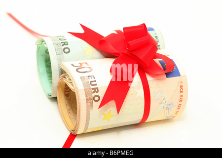 rolled euro banknotes fifty and hundred with red ribbon Stock Photo