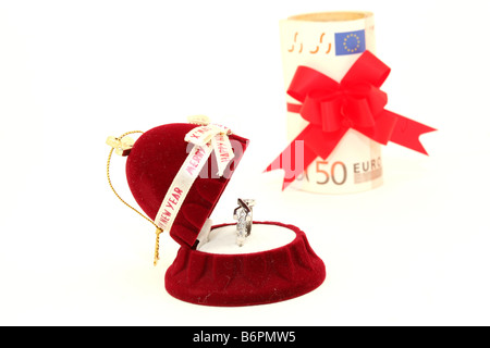 xmas gift box with white gold ring and euro money background isolated Stock Photo