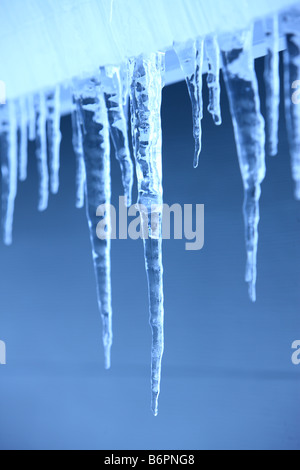 Selective focus Icicles hanging on home exterior Stock Photo
