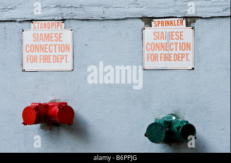 A Fire Department siamese connection is seen attached to a building in Brooklyn, New York Stock Photo