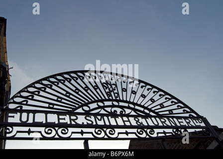 decorative ironwork on the gate of fullers griffin brewery in chiswick, west london, england, with original company name Stock Photo