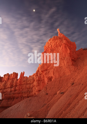 The moon sets behind moving clouds at Bryce National Park Stock Photo