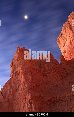 The moon sets behind moving clouds at Bryce National Park Stock Photo