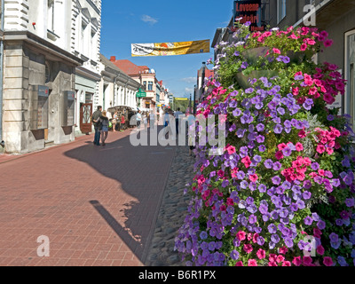 shopping street with flowers and people in the city centre town Pärnu Estonia Baltic states Stock Photo