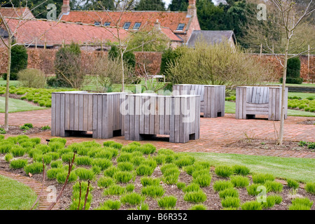 seating area amongst the drifts of grass at Scampston Walled Garden designed by Piet Oudolf Stock Photo