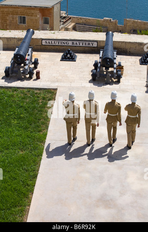 Soldiers marching towards cannons at the Saluting Battery, Upper Barracca Gardens, Valletta, Malta Stock Photo