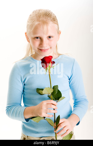 One girl holding single rose smiling close up Stock Photo